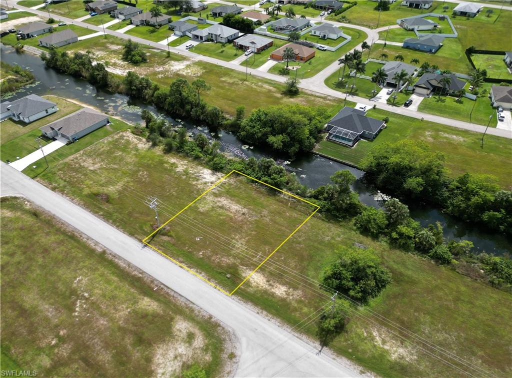 Aerial perspective of suburban area featuring a large body of water