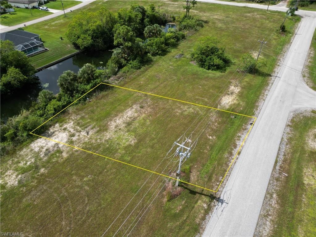 Aerial view of property's location featuring a large body of water and property parcel outlined