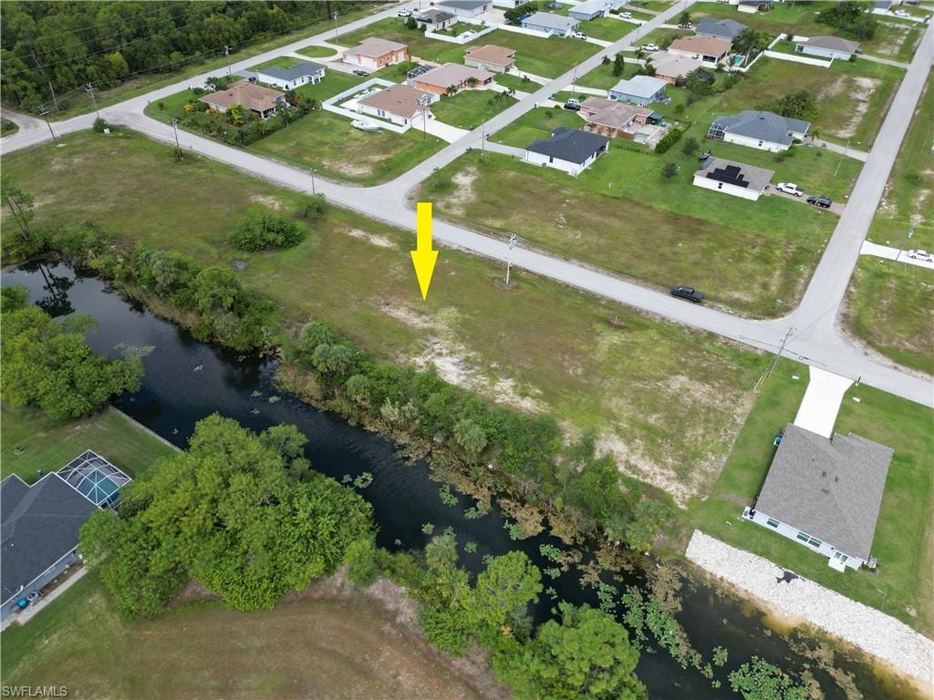 Aerial view of property and surrounding area with nearby suburban area