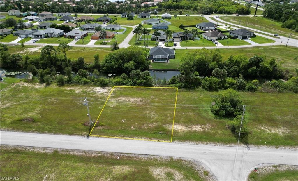Aerial view of residential area featuring property boundaries highlighted