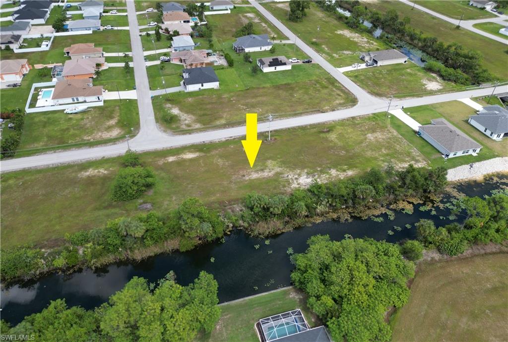 Aerial overview of property's location featuring a nearby body of water and nearby suburban area