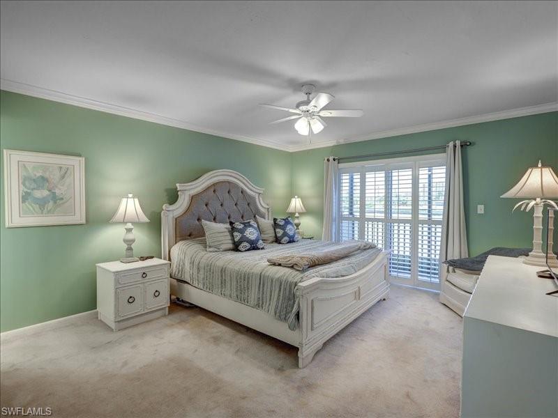 Bedroom with carpet flooring, crown molding, and ceiling fan
