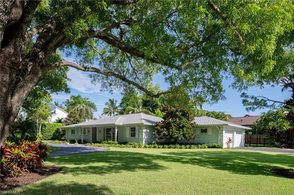 Ranch-style home with a front lawn and a garage