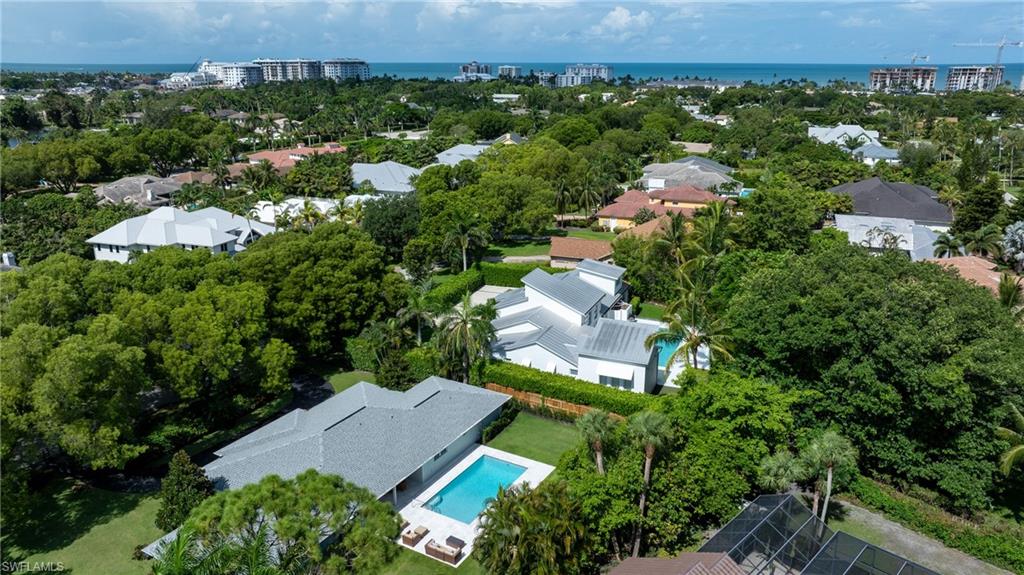 Bird's eye view of a pool and a nearby body of water