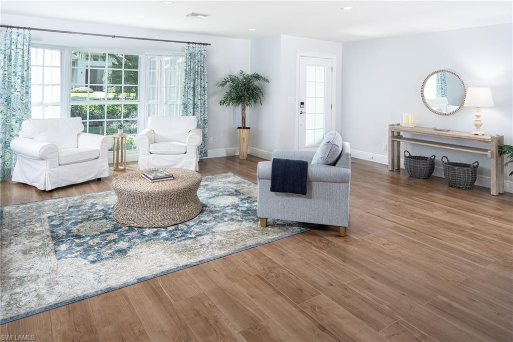 Living area featuring wood finished floors and recessed lighting