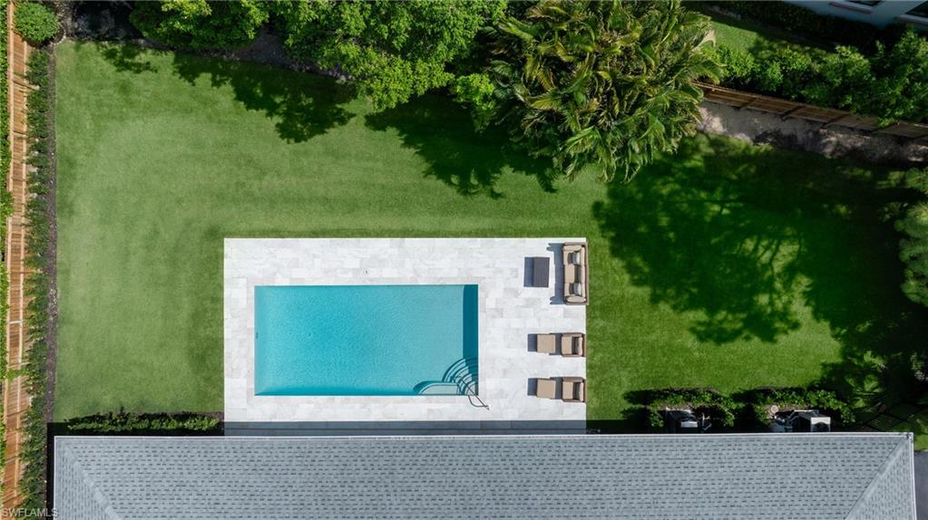 View of subject property with a pool area