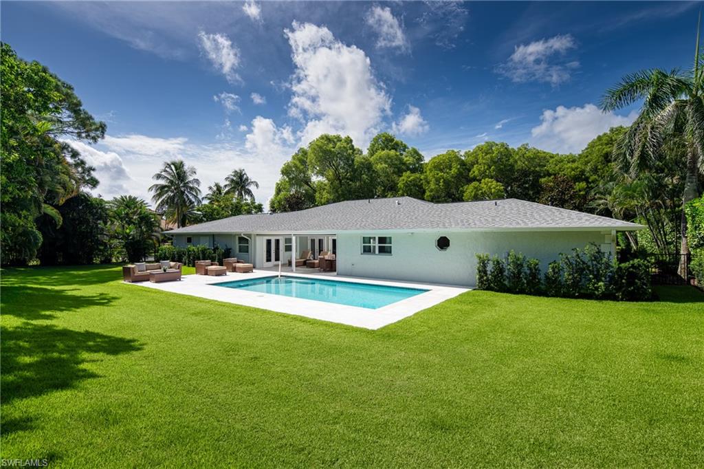 Swimming pool featuring an outdoor living space, a yard, a patio, and french doors