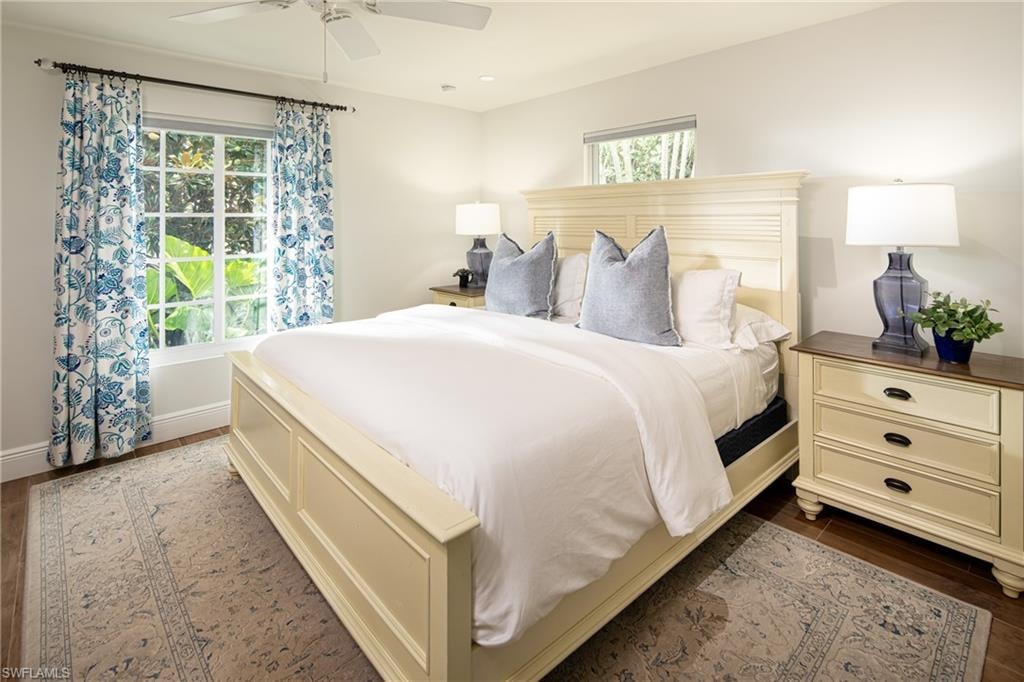 Bedroom with dark wood finished floors and a ceiling fan
