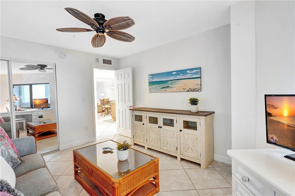 Bedroom area featuring light tile patterned flooring and a ceiling fan