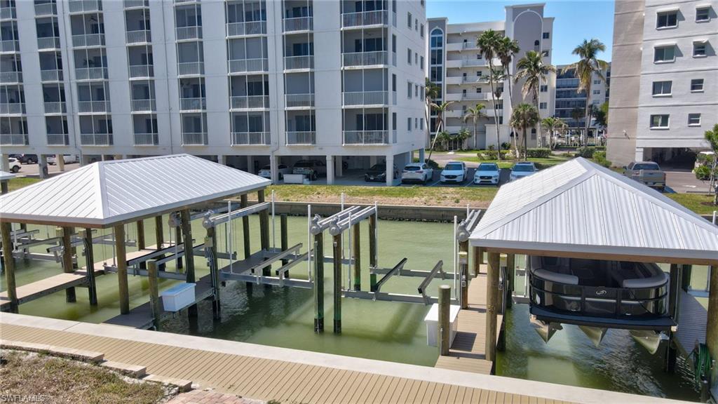 Dock area with boat lift and a water view