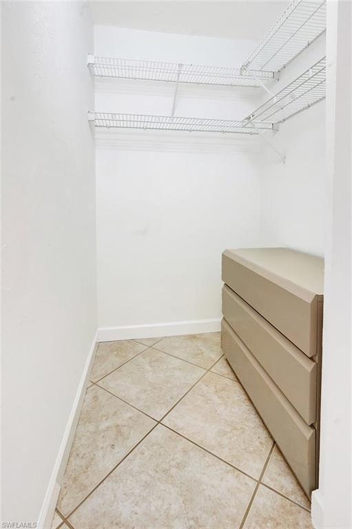Walk in closet featuring light tile patterned flooring