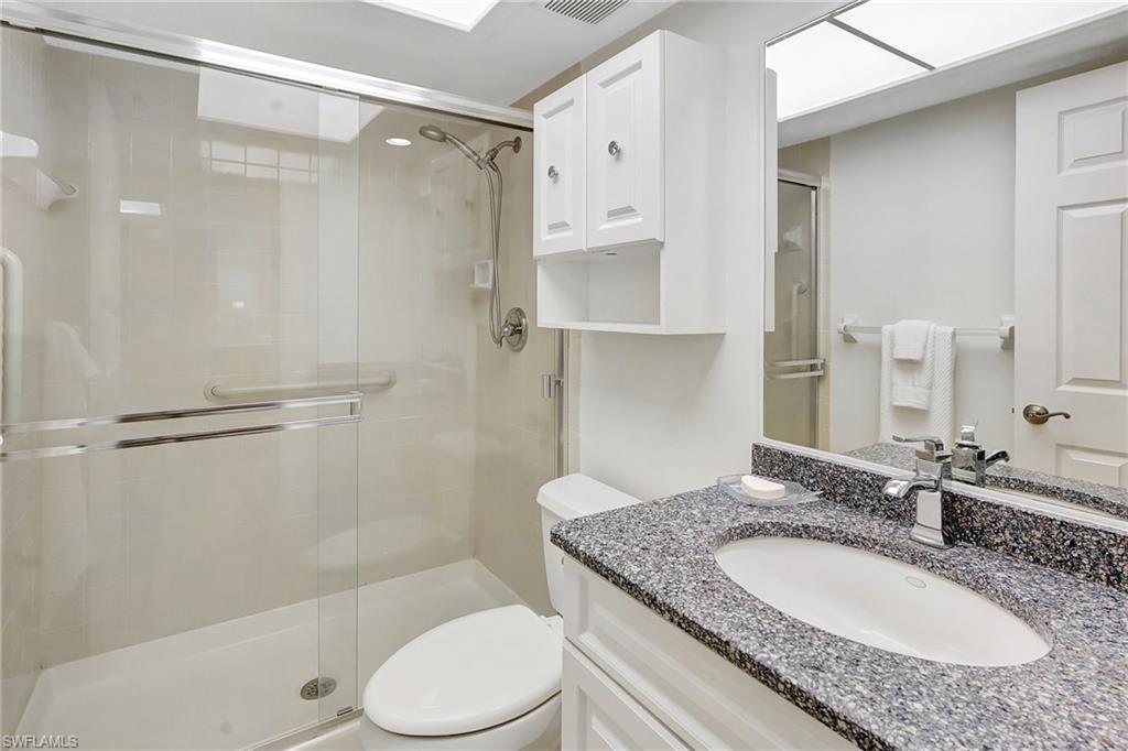 Full bath featuring a stall shower and vanity