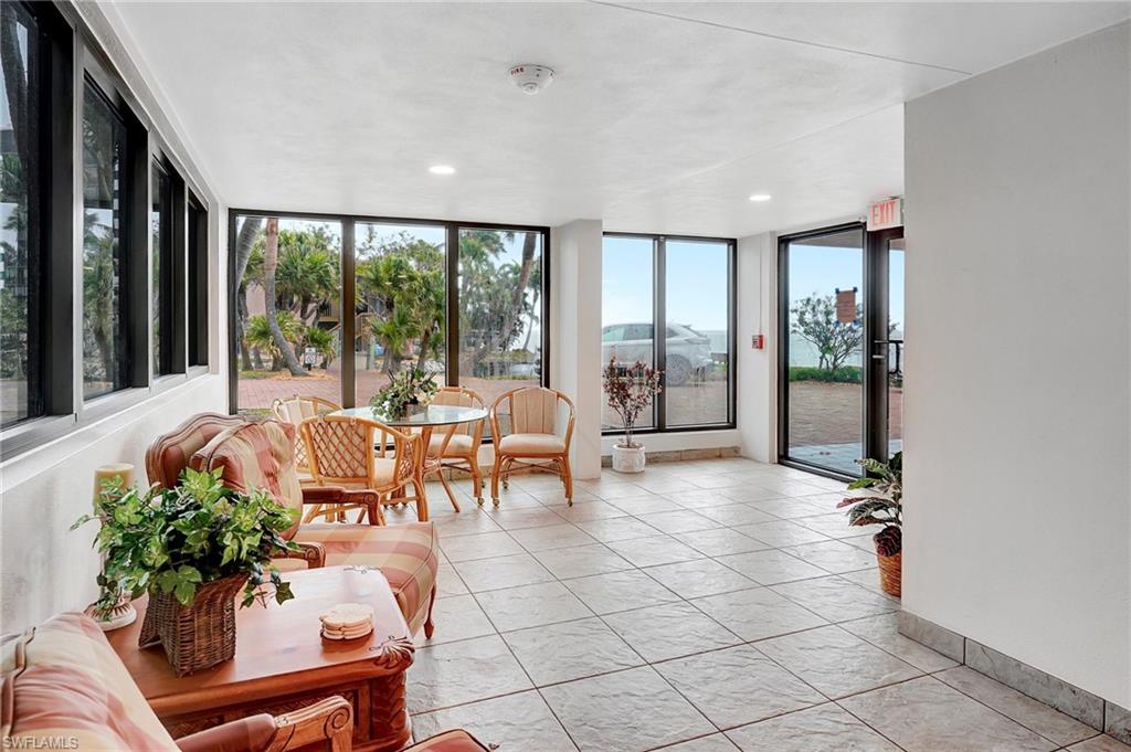Sunroom / solarium featuring expansive windows, recessed lighting, and tile patterned floors