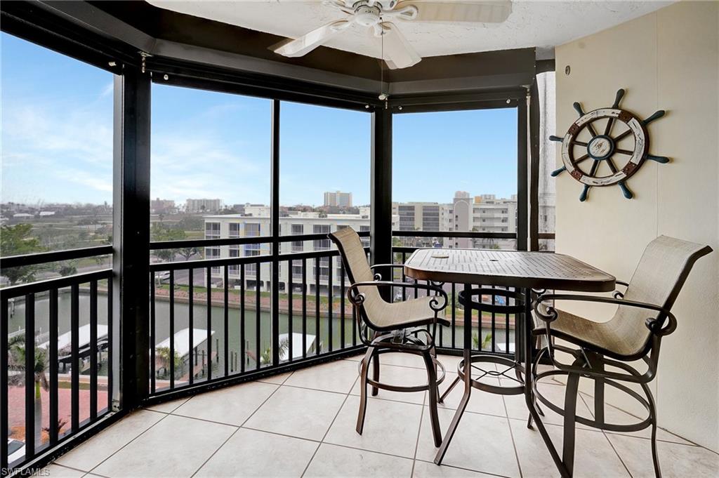 Sunroom with a water view and tile patterned flooring