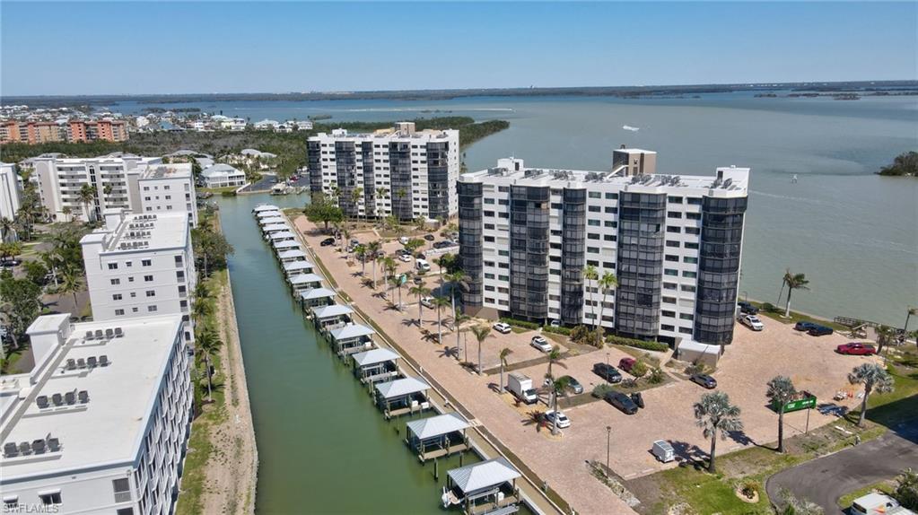 Drone / aerial view of apartment complex / building and a nearby body of water