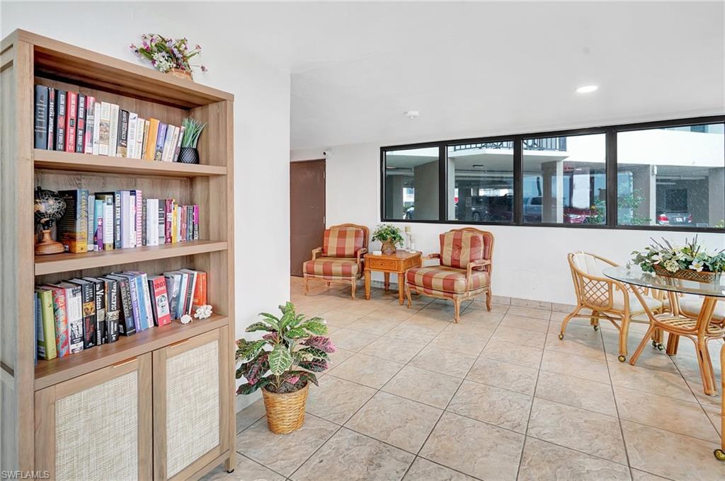Living area with light tile patterned flooring and recessed lighting