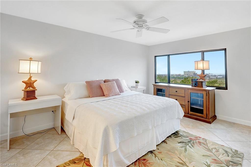 Bedroom with light tile patterned floors and ceiling fan