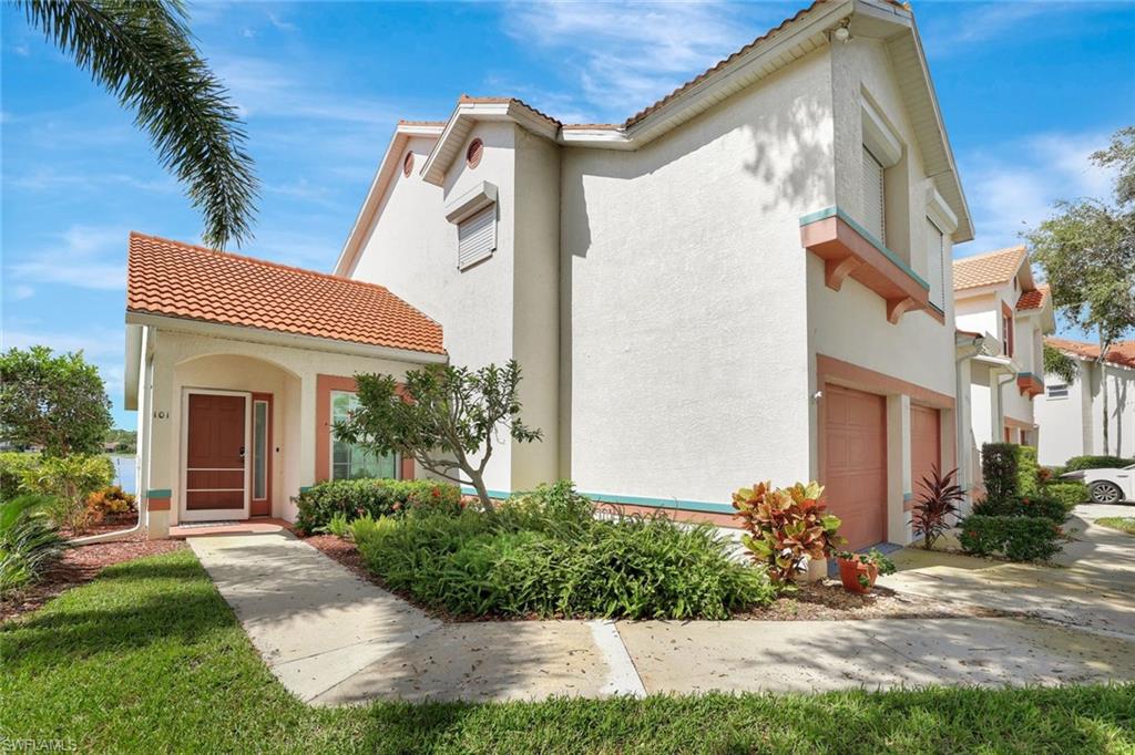 Mediterranean / spanish house featuring a tile roof, stucco siding, and an attached garage
