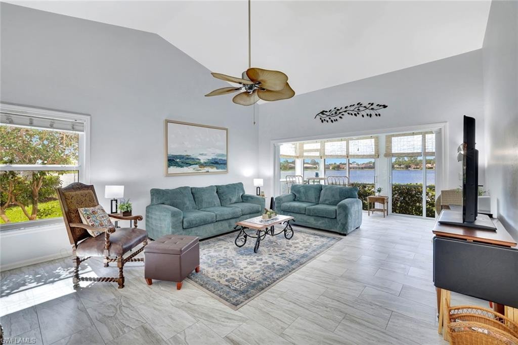 Living room with high vaulted ceiling and ceiling fan