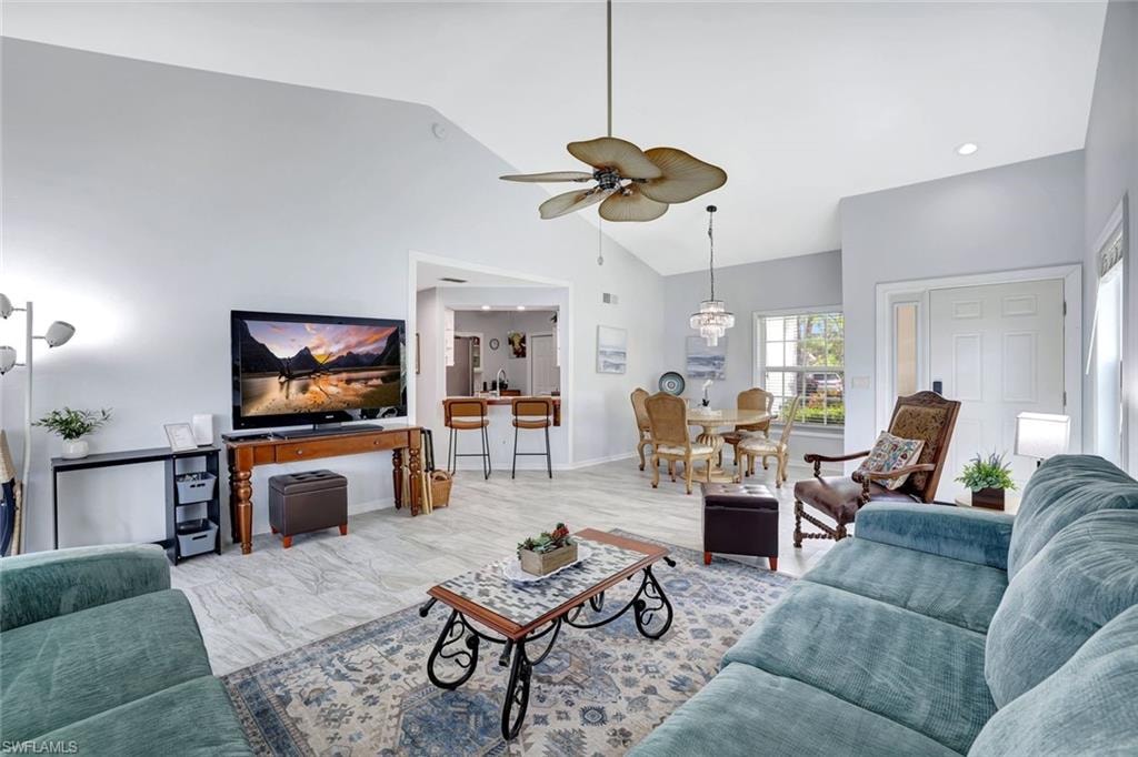 Living room featuring ceiling fan, high vaulted ceiling, and recessed lighting