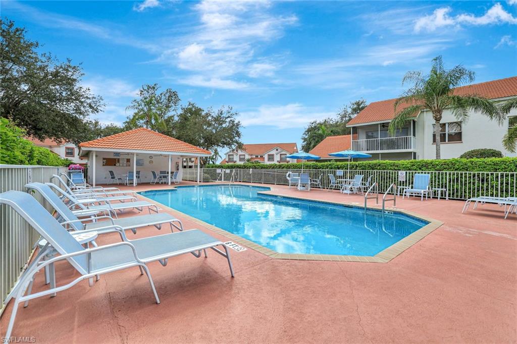 Community pool featuring a patio and a residential view