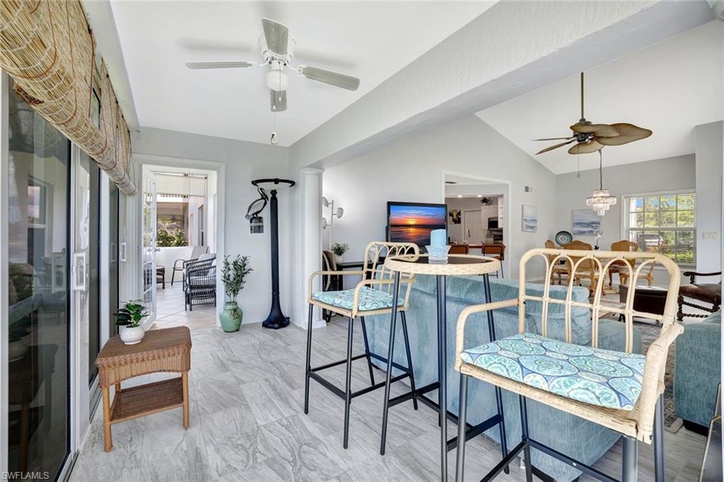 Dining space with a ceiling fan and vaulted ceiling