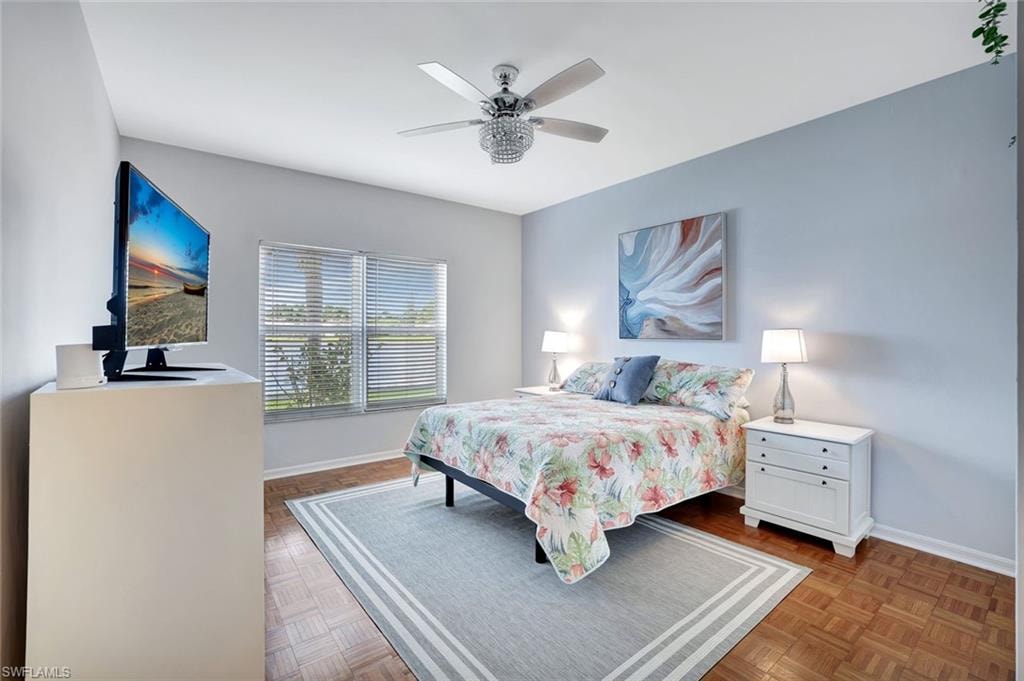 Bedroom with ceiling fan and baseboards