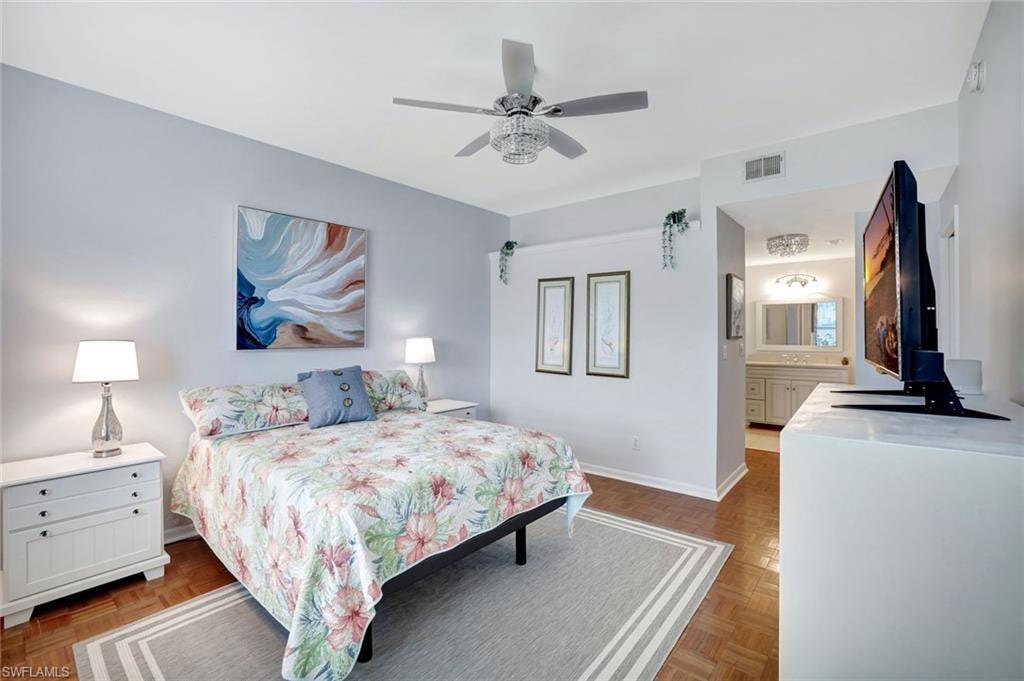 Bedroom with ceiling fan and ensuite bath