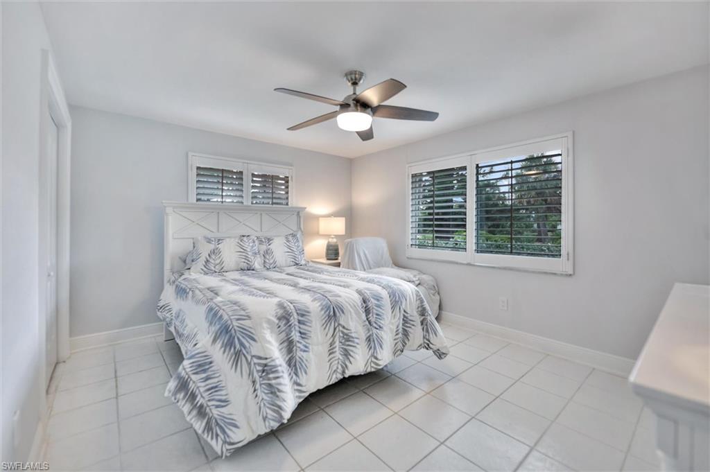 Bedroom featuring light tile patterned floors and a ceiling fan