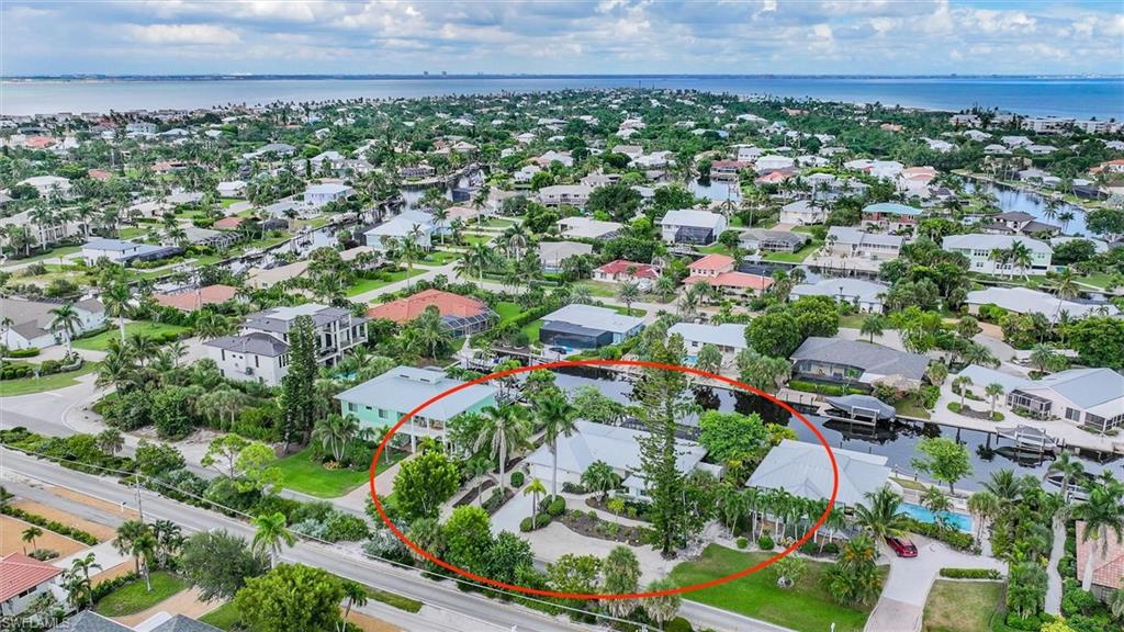 View of property location featuring a nearby body of water and nearby suburban area