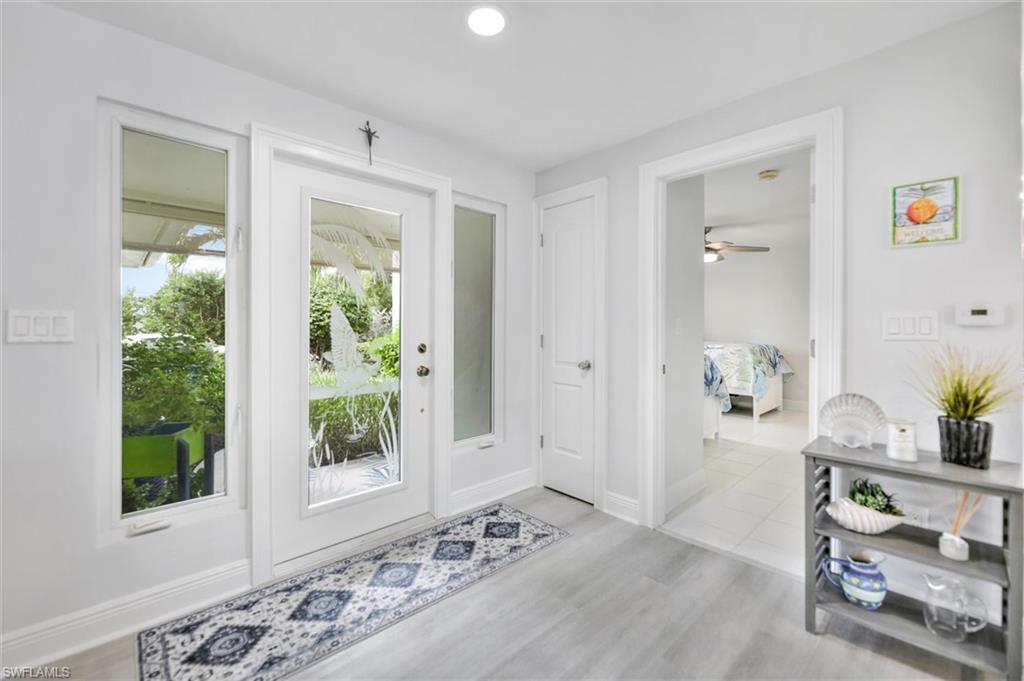 Doorway featuring wood finished floors and recessed lighting