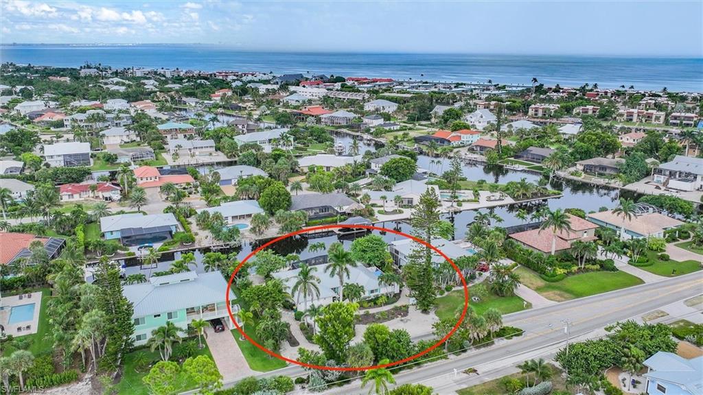 View of property location featuring a large body of water and nearby suburban area