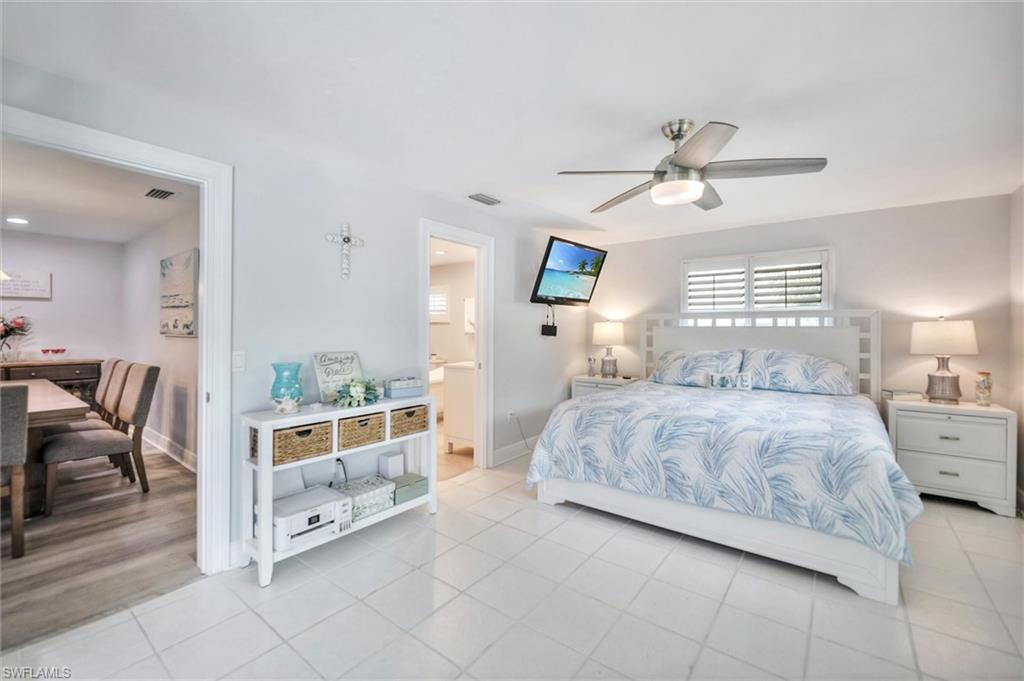 Bedroom with tile patterned floors and ceiling fan