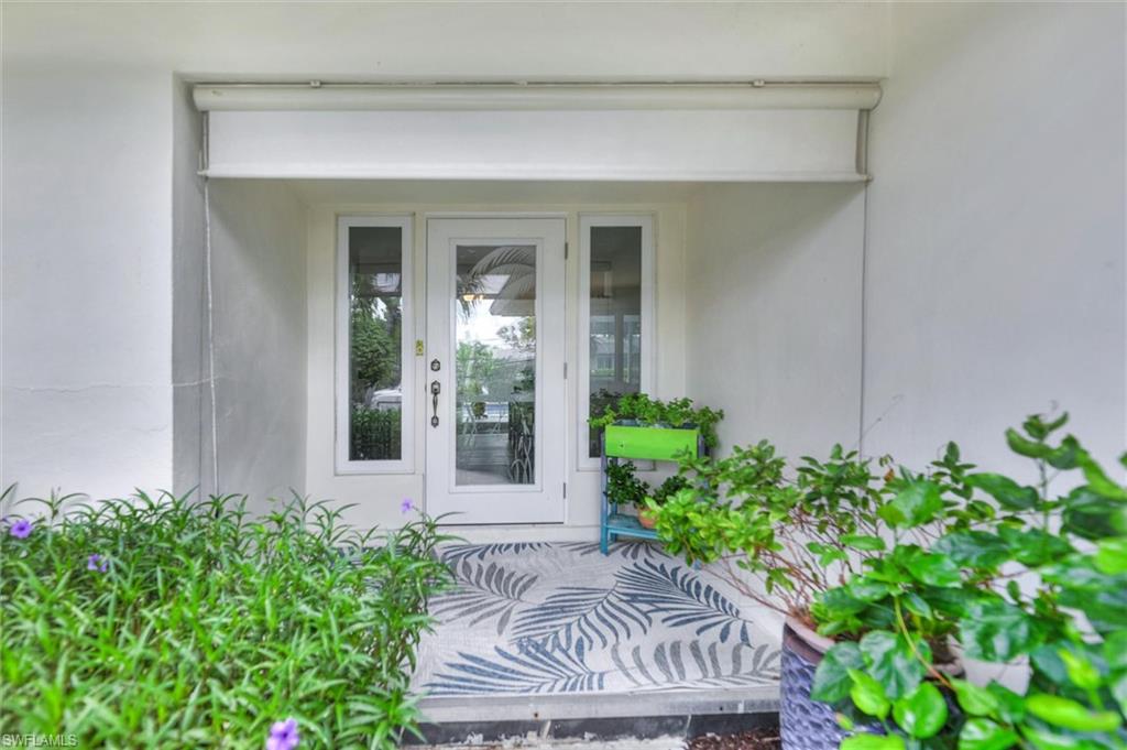 Property entrance featuring stucco siding