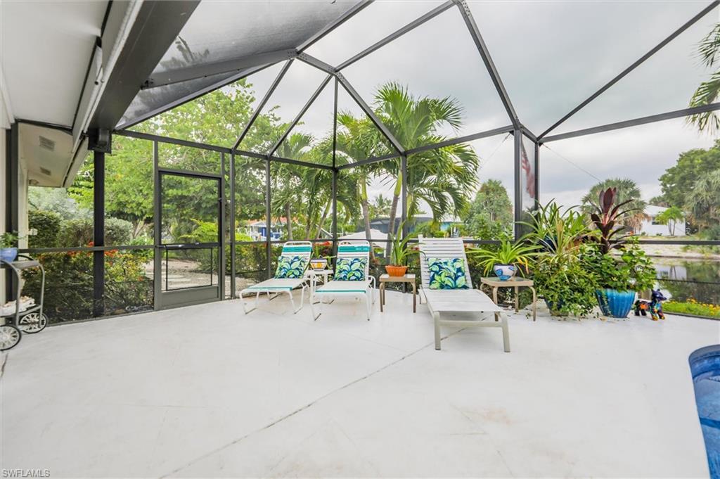 View of patio / terrace with a lanai, a sunroom, and an outdoor pool