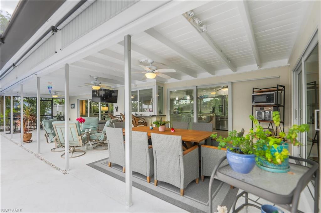 Sunroom / solarium with healthy amount of natural light and beamed ceiling