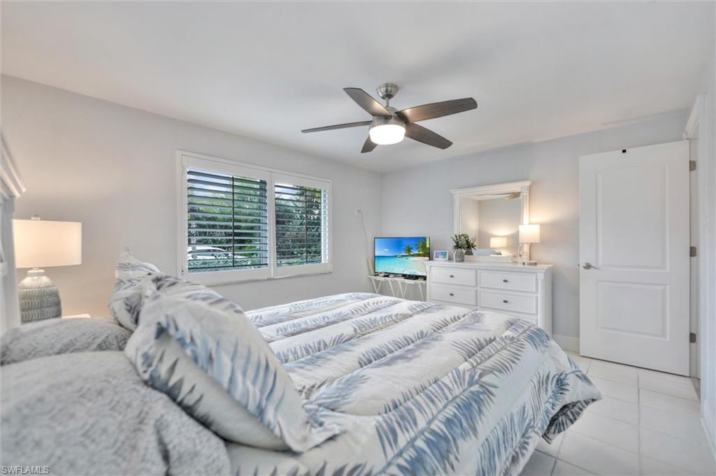 Bedroom featuring light tile patterned floors and a ceiling fan
