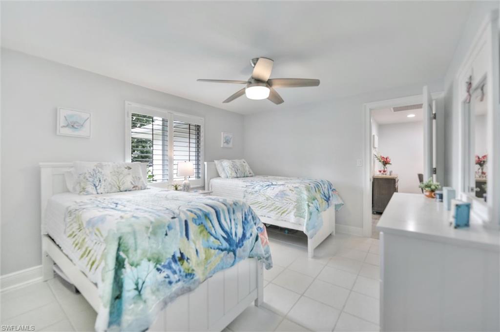 Bedroom featuring light tile patterned floors and ceiling fan