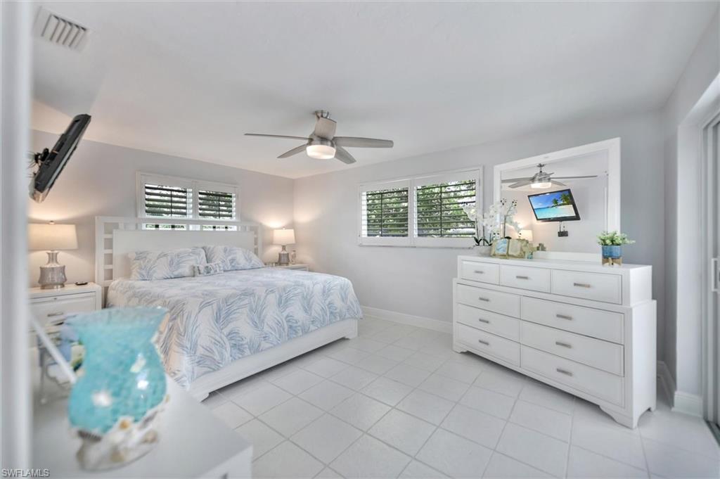 Bedroom featuring light tile patterned floors and ceiling fan