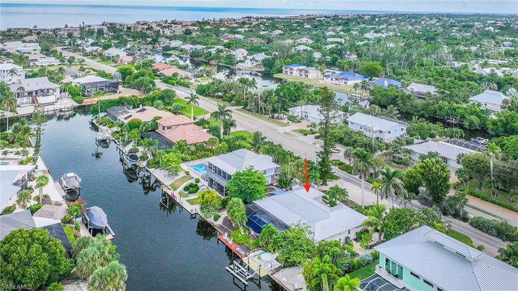 Aerial perspective of suburban area with a large body of water