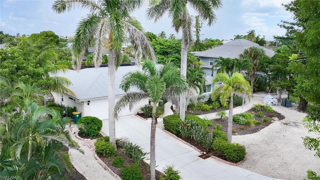 View of front facade with concrete driveway and a garage