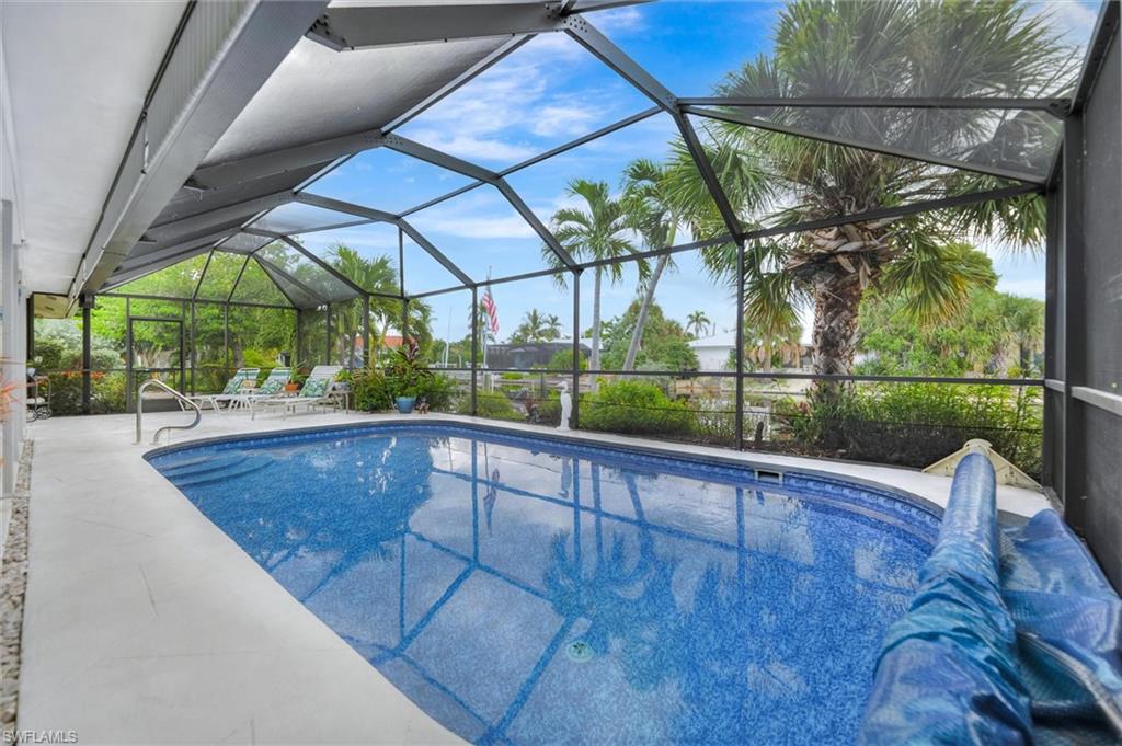 Outdoor pool with a sunroom, a lanai, and a patio area