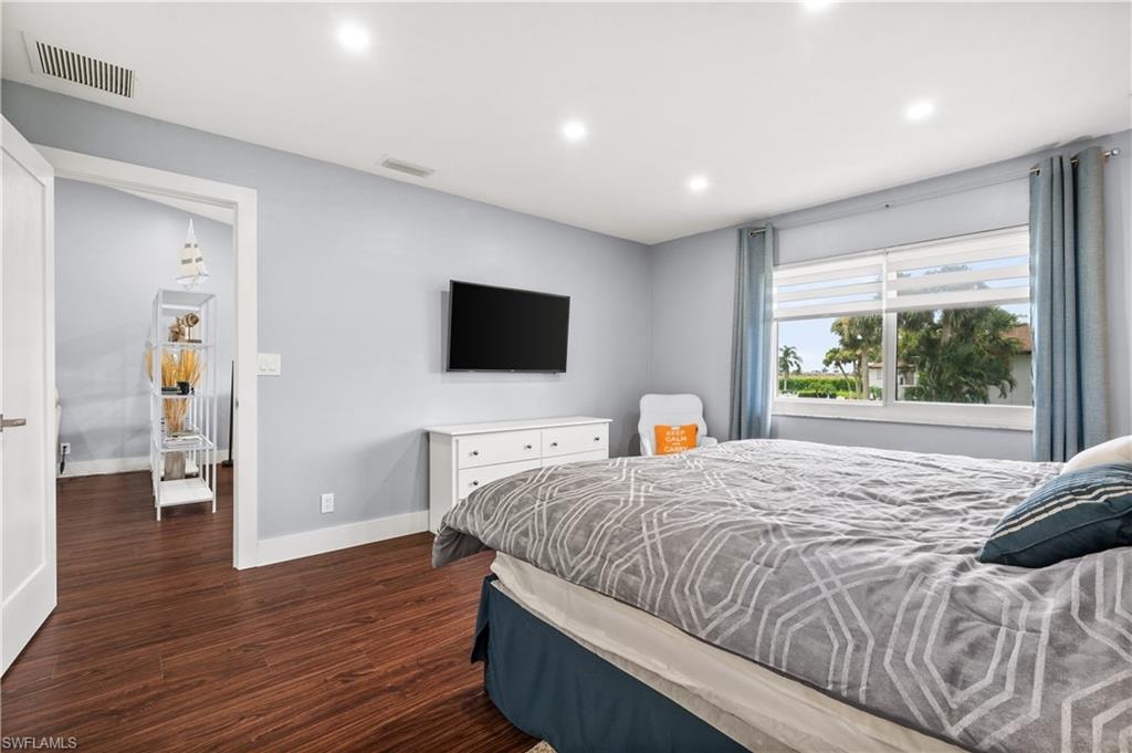 Bedroom with recessed lighting and dark wood finished floors