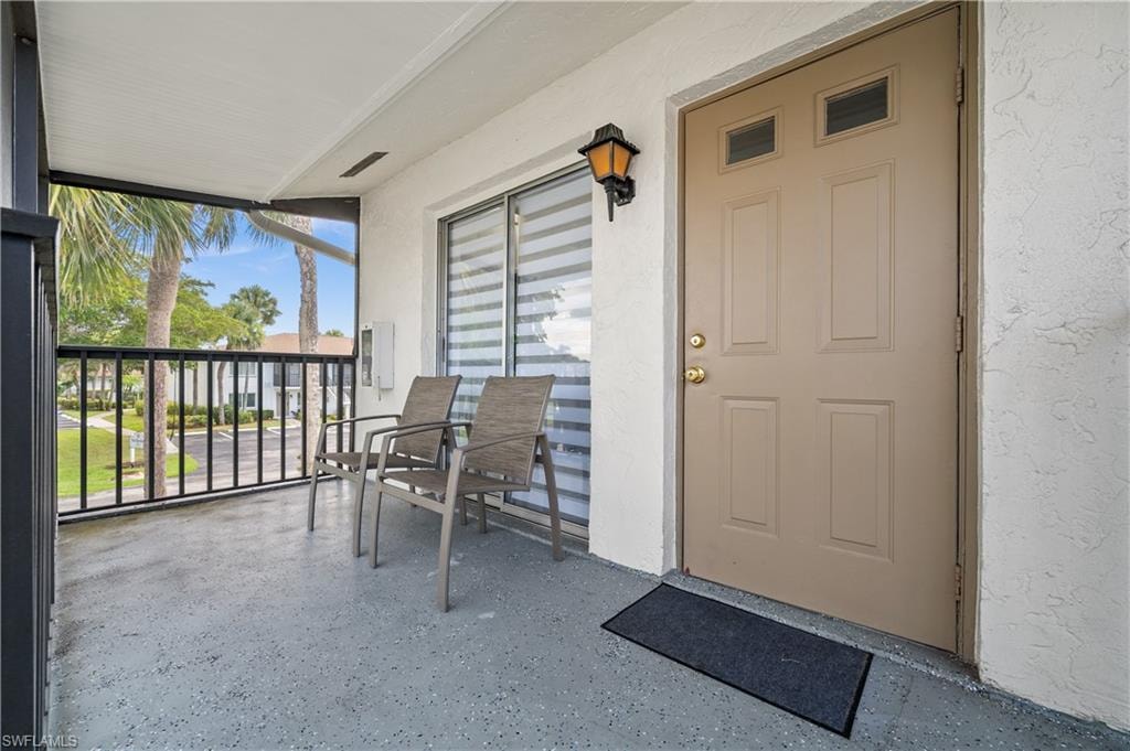 View of exterior entry featuring stucco siding