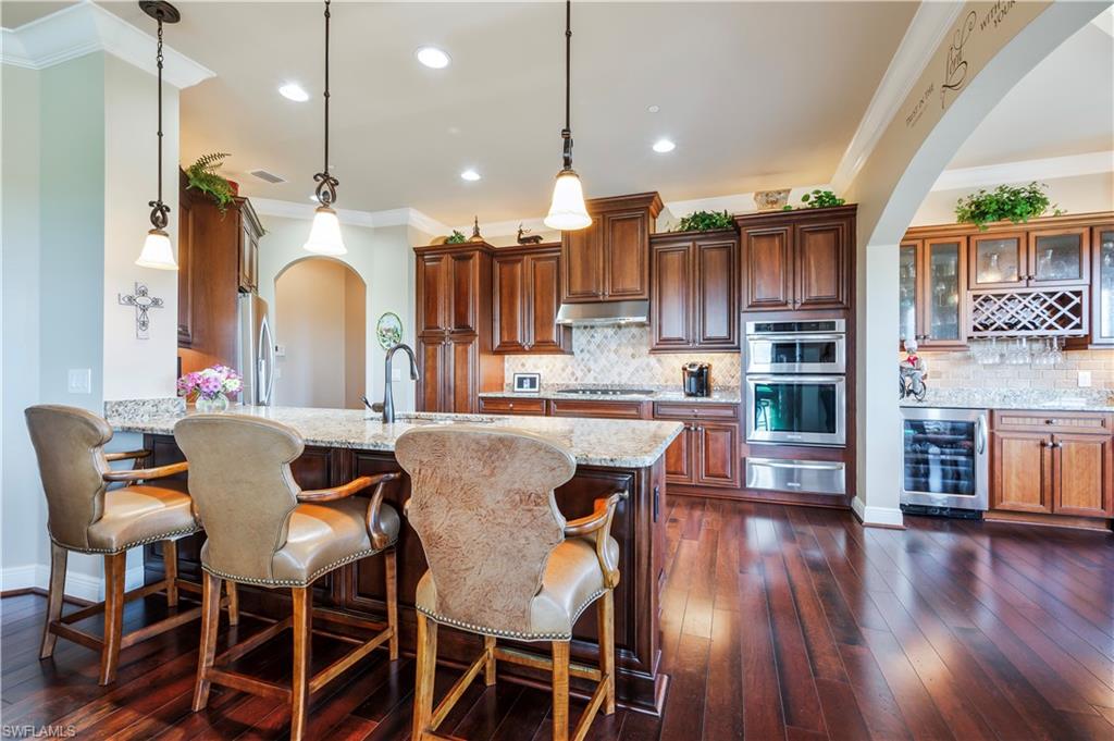 Open kitchen with bar stool seating.