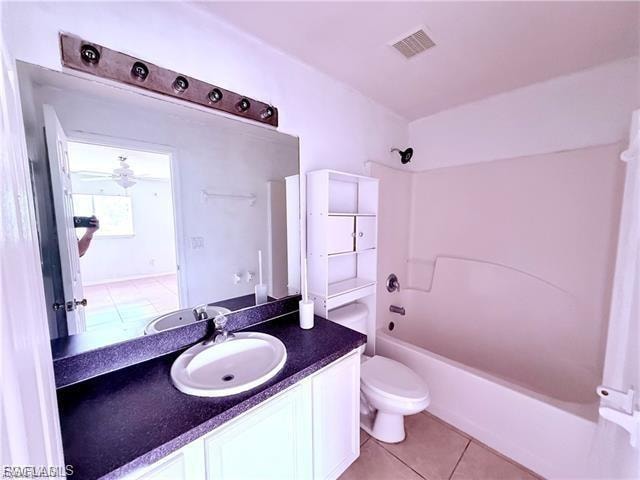 Bathroom with shower / washtub combination, light tile patterned floors, vanity, and a ceiling fan
