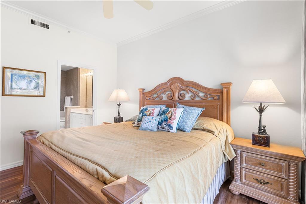 Primary bedroom offers crown molding, ensuite bathroom
