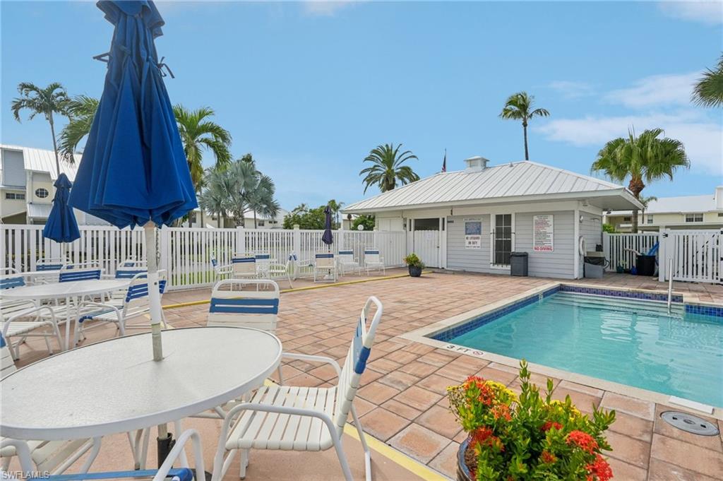 Community pool with a patio and outdoor dining space