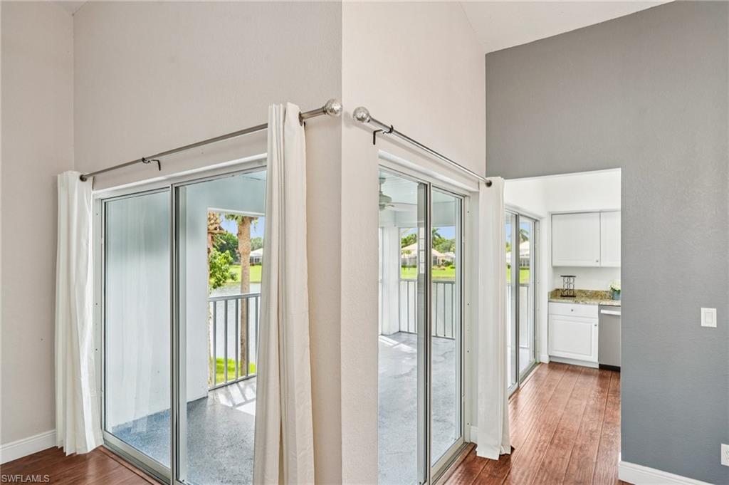 Doorway featuring hardwood / wood-style floors, plenty of natural light, and a high ceiling