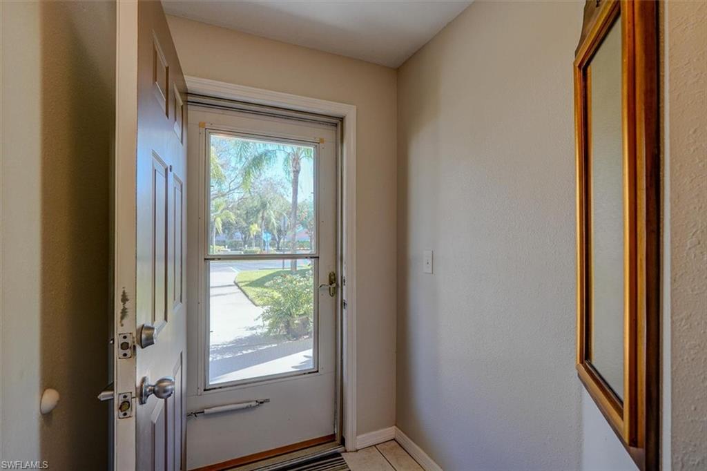 Doorway featuring baseboards and tile patterned flooring